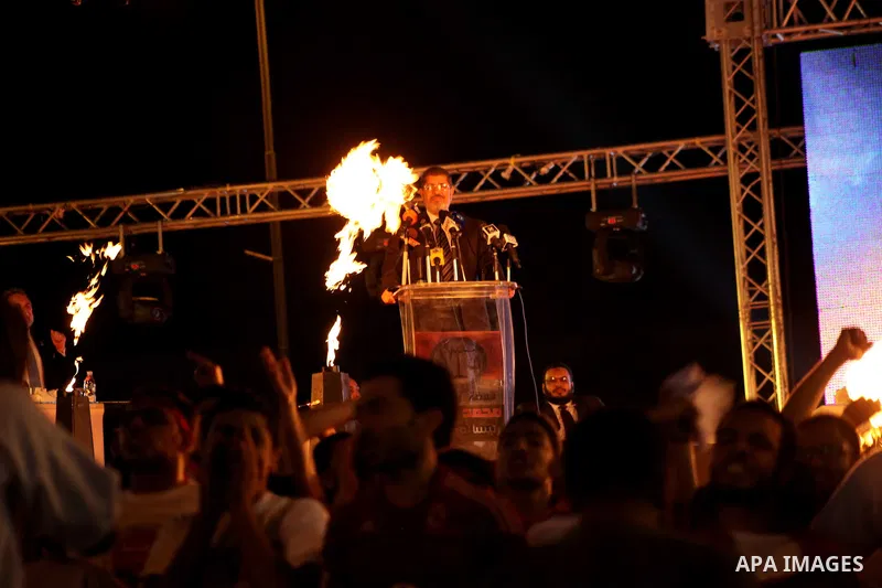Mohamed Mursi, head of the Muslim Brotherhood's political party and the Brotherhood's presidential candidate, speaks during his last campaign rally in front of the Abdeen Palace Museum in Cairo May 20, 2012. Mursi has ca...