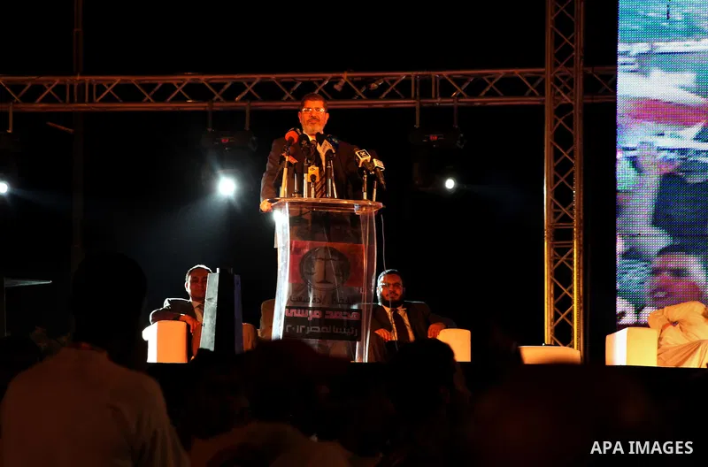 Mohamed Mursi, head of the Muslim Brotherhood's political party and the Brotherhood's presidential candidate, speaks during his last campaign rally in front of the Abdeen Palace Museum in Cairo May 20, 2012. Mursi has ca...