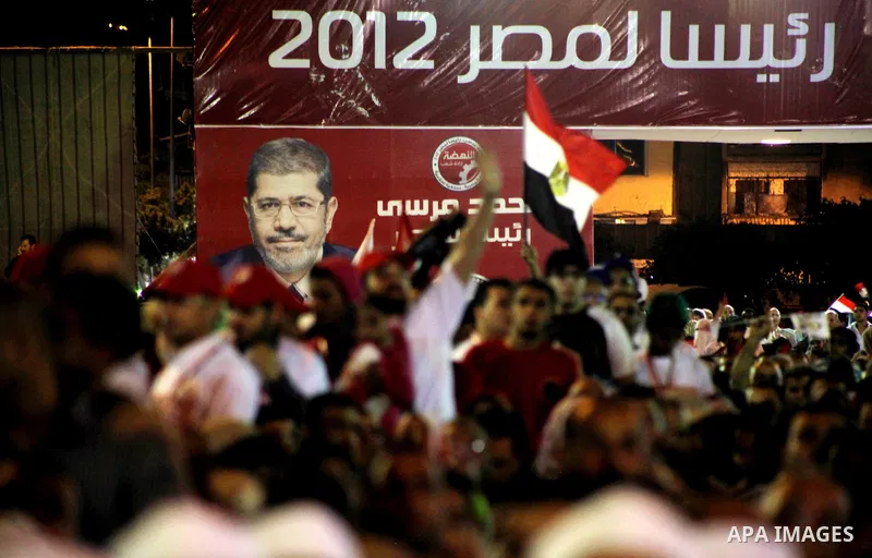 Supporters of the Muslim Brotherhood's presidential candidate Mohammed Mursi, unseen, hold a rally Cairo, Egypt, Sunday, May 20, 2012. Egypt's election commission is vowing that next week's presidential election will be...