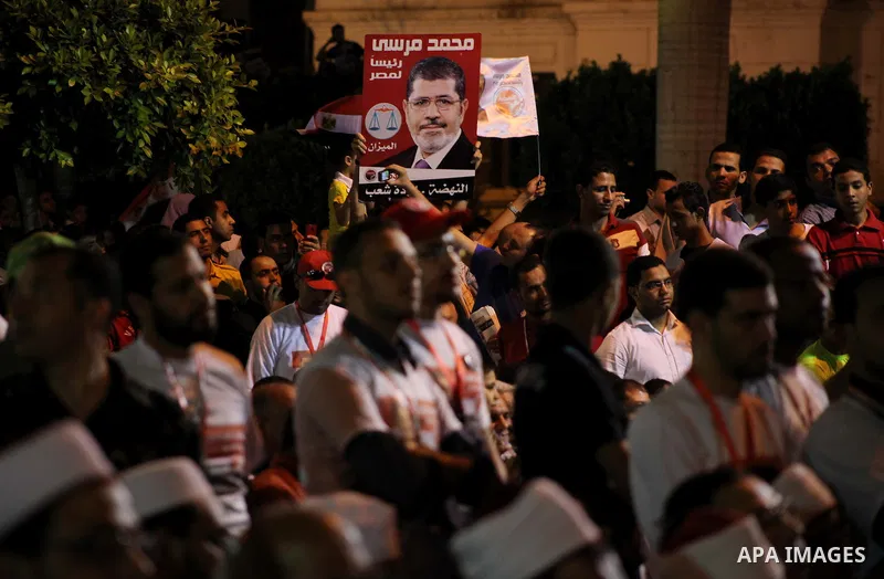 Supporters of the Muslim Brotherhood's presidential candidate Mohammed Mursi, unseen, hold a rally Cairo, Egypt, Sunday, May 20, 2012. Egypt's election commission is vowing that next week's presidential election will be...