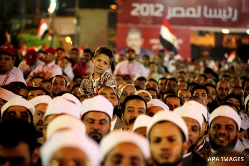 Supporters of the Muslim Brotherhood's presidential candidate Mohammed Mursi, unseen, hold a rally Cairo, Egypt, Sunday, May 20, 2012. Egypt's election commission is vowing that next week's presidential election will be...