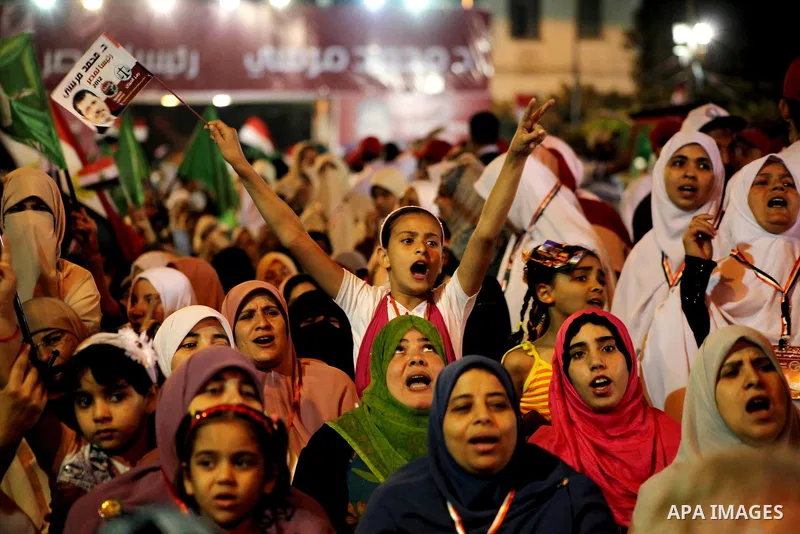 Supporters of the Muslim Brotherhood's presidential candidate Mohammed Mursi, unseen, hold a rally Cairo, Egypt, Sunday, May 20, 2012. Egypt's election commission is vowing that next week's presidential election will be...