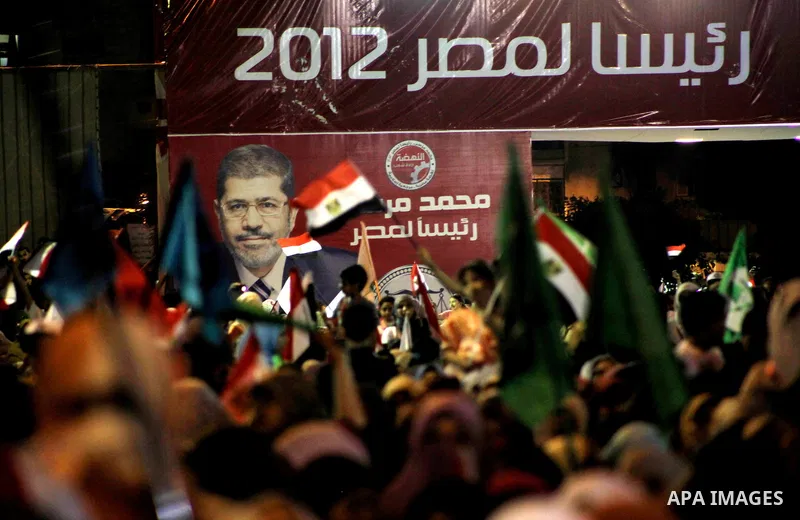 Supporters of the Muslim Brotherhood's presidential candidate Mohammed Mursi, unseen, hold a rally Cairo, Egypt, Sunday, May 20, 2012. Egypt's election commission is vowing that next week's presidential election will be...