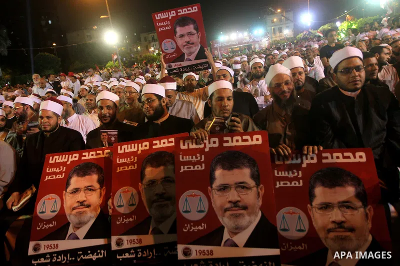 Supporters of the Muslim Brotherhood's presidential candidate Mohammed Mursi, unseen, hold a rally Cairo, Egypt, Sunday, May 20, 2012. Egypt's election commission is vowing that next week's presidential election will be...