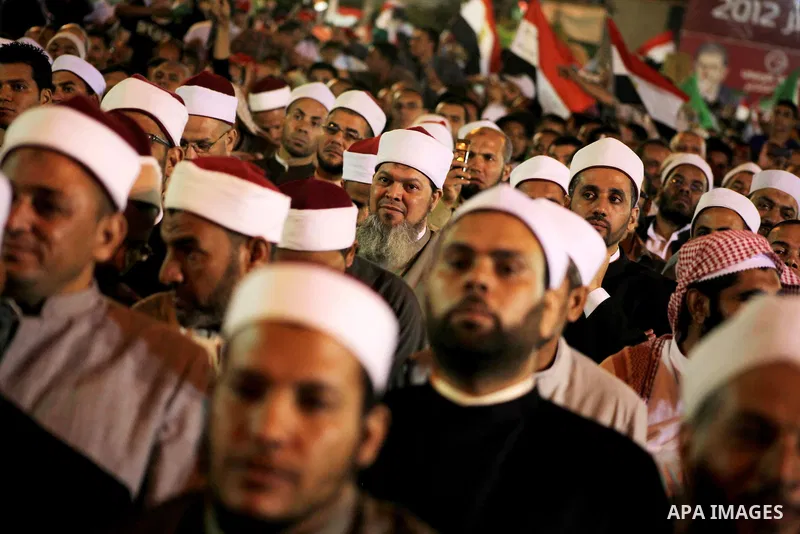 Supporters of the Muslim Brotherhood's presidential candidate Mohammed Mursi, unseen, hold a rally Cairo, Egypt, Sunday, May 20, 2012. Egypt's election commission is vowing that next week's presidential election will be...