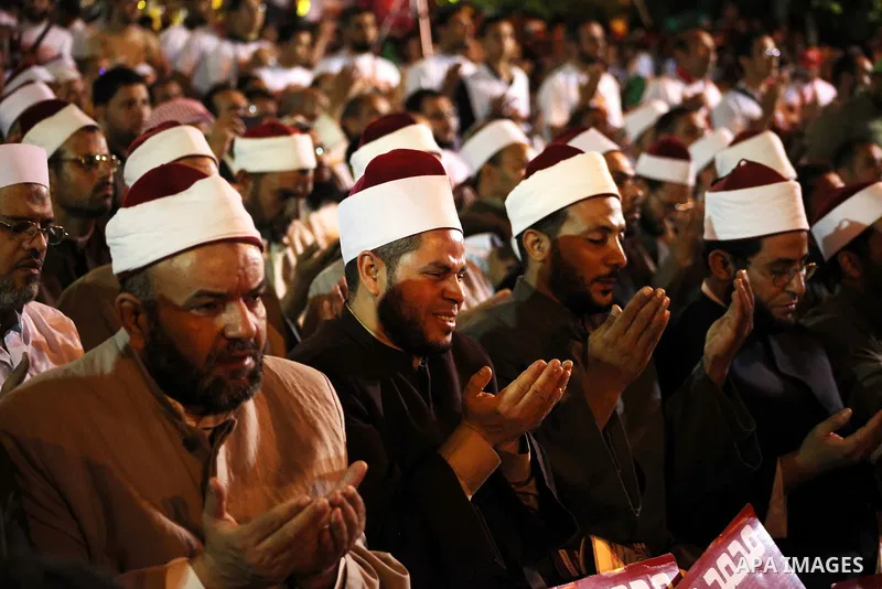 Supporters of the Muslim Brotherhood's presidential candidate Mohammed Mursi, unseen, hold a rally Cairo, Egypt, Sunday, May 20, 2012. Egypt's election commission is vowing that next week's presidential election will be...