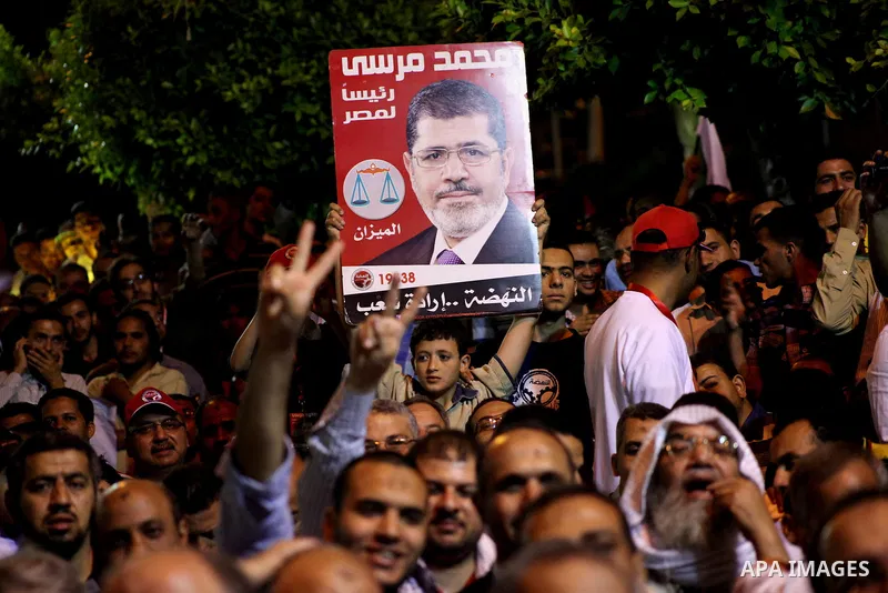 Supporters of the Muslim Brotherhood's presidential candidate Mohammed Mursi, unseen, hold a rally Cairo, Egypt, Sunday, May 20, 2012. Egypt's election commission is vowing that next week's presidential election will be...