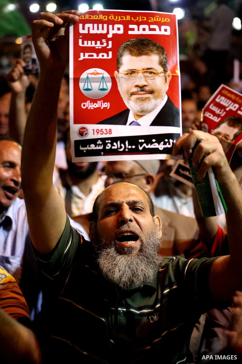 Supporters of the Muslim Brotherhood's presidential candidate Mohammed Mursi, unseen, hold a rally Cairo, Egypt, Sunday, May 20, 2012. Egypt's election commission is vowing that next week's presidential election will be...