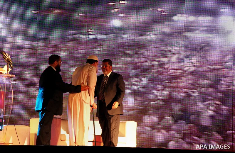 Mohamed Mursi, head of the Muslim Brotherhood's political party and the Brotherhood's presidential candidate, attends during his last campaign rally in front of the Abdeen Palace Museum in Cairo May 20, 2012. Mursi has c...