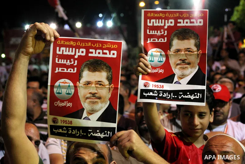 Supporters of the Muslim Brotherhood's presidential candidate Mohammed Mursi, unseen, hold a rally Cairo, Egypt, Sunday, May 20, 2012. Egypt's election commission is vowing that next week's presidential election will be...