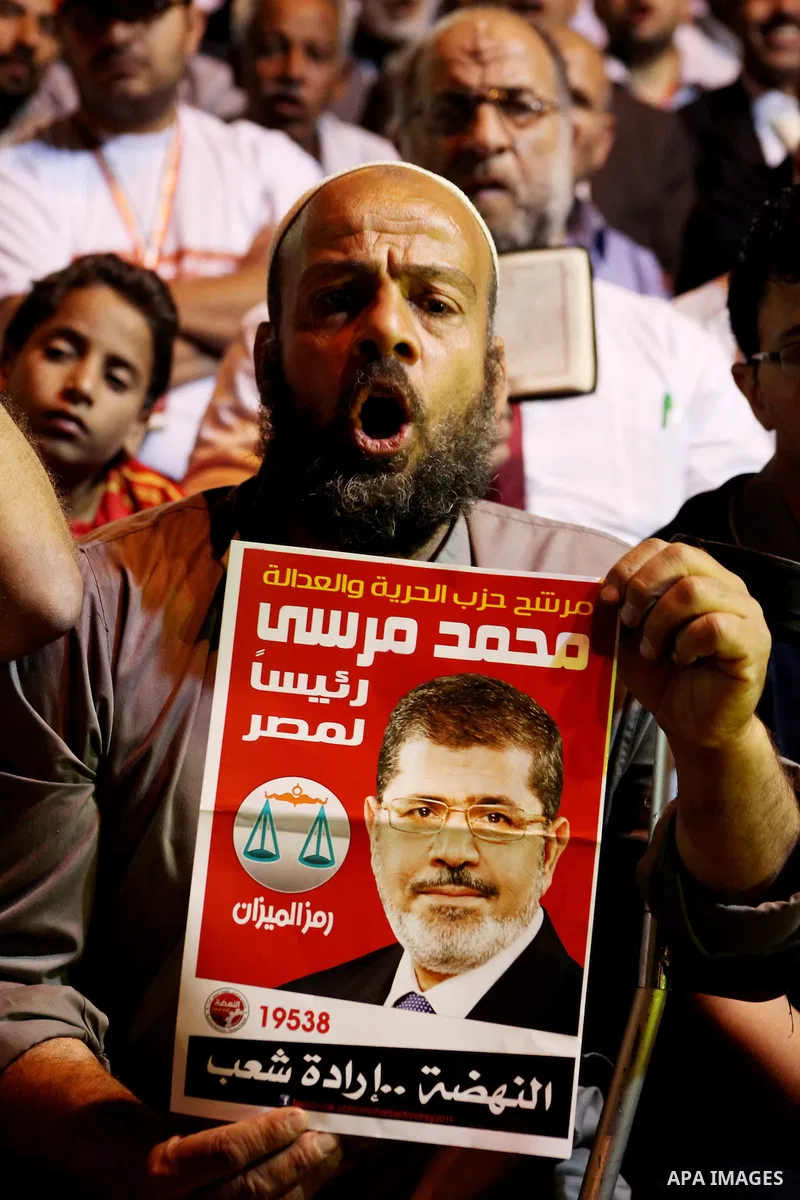 Supporters of the Muslim Brotherhood's presidential candidate Mohammed Mursi, unseen, hold a rally Cairo, Egypt, Sunday, May 20, 2012. Egypt's election commission is vowing that next week's presidential election will be...