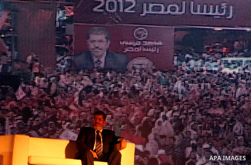 Mohamed Mursi, head of the Muslim Brotherhood's political party and the Brotherhood's presidential candidate, attends during his last campaign rally in front of the Abdeen Palace Museum in Cairo May 20, 2012. Mursi has c...