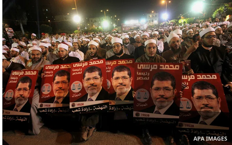 Supporters of the Muslim Brotherhood's presidential candidate Mohammed Mursi, unseen, hold a rally Cairo, Egypt, Sunday, May 20, 2012. Egypt's election commission is vowing that next week's presidential election will be...