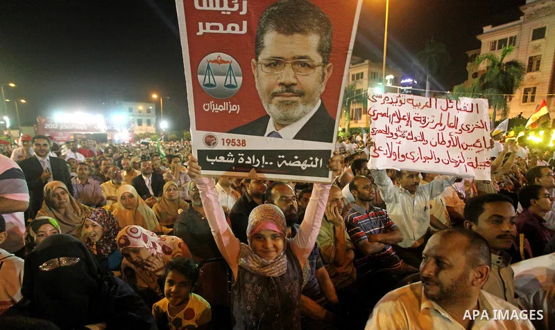 Supporters of the Muslim Brotherhood's presidential candidate Mohammed Mursi, unseen, hold a rally Cairo, Egypt, Sunday, May 20, 2012. Egypt's election commission is vowing that next week's presidential election will be...