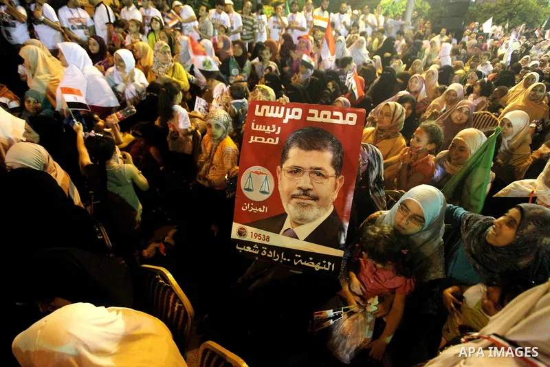 Supporters of the Muslim Brotherhood's presidential candidate Mohammed Mursi, unseen, hold a rally Cairo, Egypt, Sunday, May 20, 2012. Egypt's election commission is vowing that next week's presidential election will be...