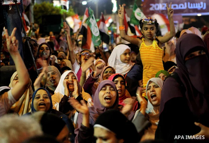 Supporters of the Muslim Brotherhood's presidential candidate Mohammed Mursi, unseen, hold a rally Cairo, Egypt, Sunday, May 20, 2012. Egypt's election commission is vowing that next week's presidential election will be...