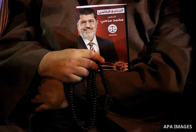 Supporters of the Muslim Brotherhood's presidential candidate Mohammed Mursi, unseen, hold a rally Cairo, Egypt, Sunday, May 20, 2012. Egypt's election commission is vowing that next week's presidential election will be...