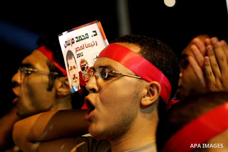 Supporters of the Muslim Brotherhood's presidential candidate Mohammed Mursi, unseen, hold a rally Cairo, Egypt, Sunday, May 20, 2012. Egypt's election commission is vowing that next week's presidential election will be...