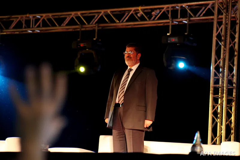 Mohamed Mursi, head of the Muslim Brotherhood's political party and the Brotherhood's presidential candidate, attends during his last campaign rally in front of the Abdeen Palace Museum in Cairo May 20, 2012. Mursi has c...