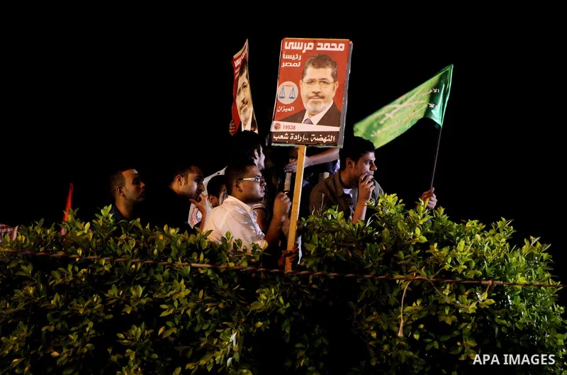 Supporters of the Muslim Brotherhood's presidential candidate Mohammed Mursi, unseen, hold a rally Cairo, Egypt, Sunday, May 20, 2012. Egypt's election commission is vowing that next week's presidential election will be...