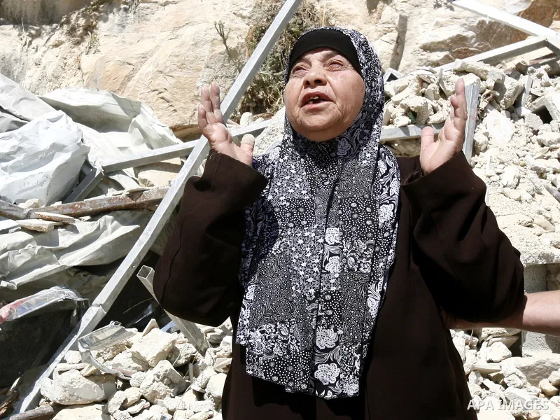 Palestinians survey the damage their house into the Jerusalem's old city on May 20, 2012. Thousands of Israelis marched into Jerusalem's old city to celebrate Jerusalem Day when the Jewish state captured the Arab eastern...
