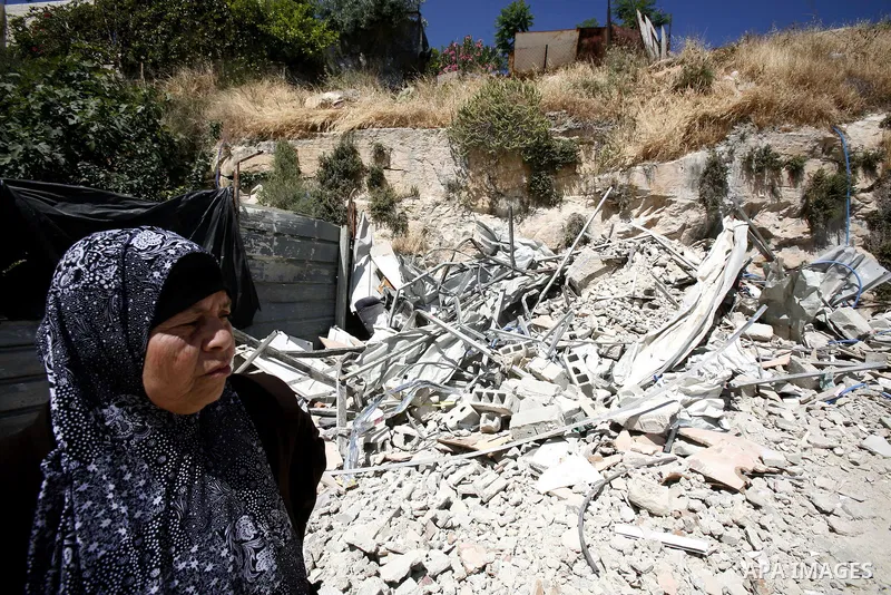 Palestinians survey the damage their house into the Jerusalem's old city on May 20, 2012. Thousands of Israelis marched into Jerusalem's old city to celebrate Jerusalem Day when the Jewish state captured the Arab eastern...