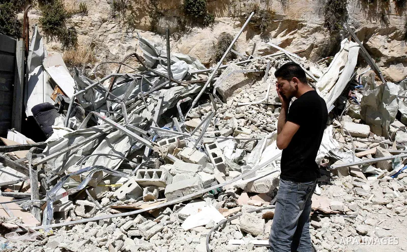 Palestinians survey the damage their house into the Jerusalem's old city on May 20, 2012. Thousands of Israelis marched into Jerusalem's old city to celebrate Jerusalem Day when the Jewish state captured the Arab eastern...