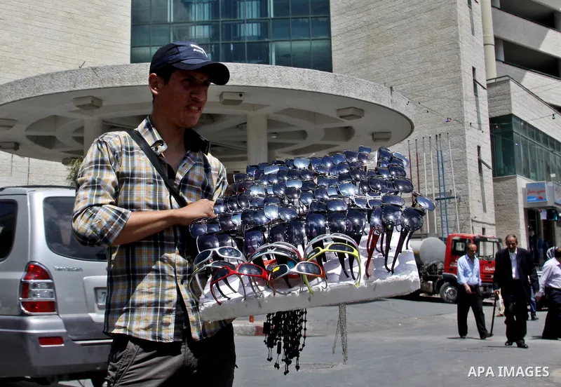 A Palestinian vendor displays sunglasses for sale in the West Bank city of Nablus,on May 21, 2012. Photo by Nedal Eshtayah