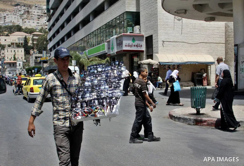 A Palestinian vendor displays sunglasses for sale in the West Bank city of Nablus,on May 21, 2012. Photo by Nedal Eshtayah