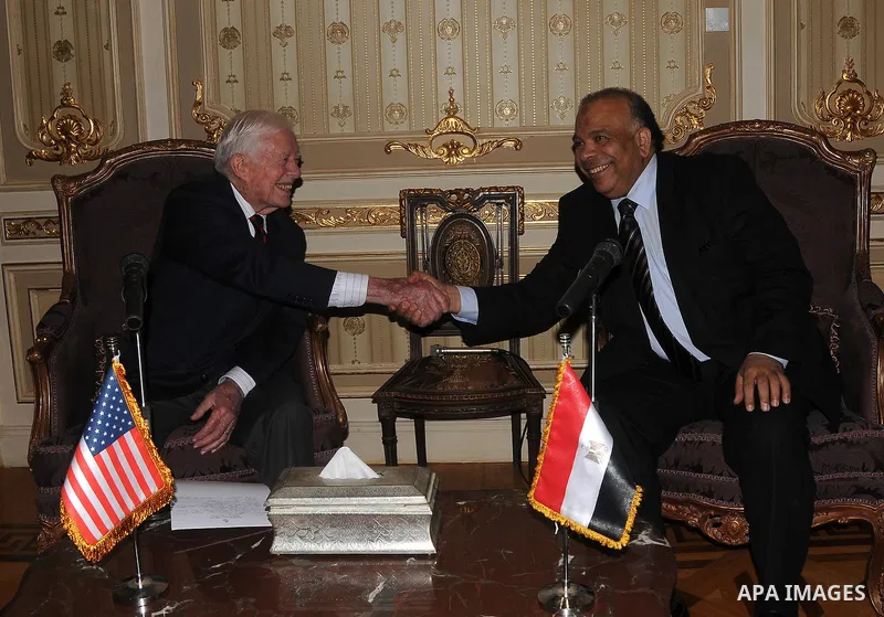 Egyptian Parliament Speaker Saad al-Katatni meets withs former US president Jimmy Carter in his office in Cairo on May 21, 2012. Carter had arrived the previous day in Egypt with a delegation from his Carter Center to mo...