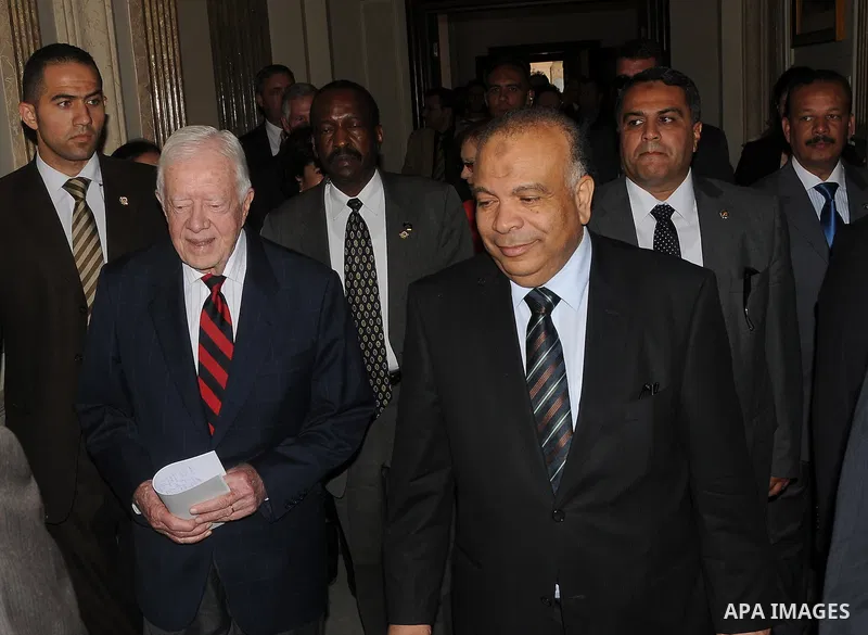 Egyptian Parliament Speaker Saad al-Katatni meets withs former US president Jimmy Carter in his office in Cairo on May 21, 2012. Carter had arrived the previous day in Egypt with a delegation from his Carter Center to mo...