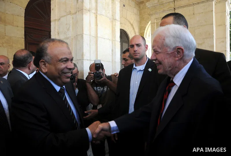 Egyptian Parliament Speaker Saad al-Katatni meets withs former US president Jimmy Carter in his office in Cairo on May 21, 2012. Carter had arrived the previous day in Egypt with a delegation from his Carter Center to mo...