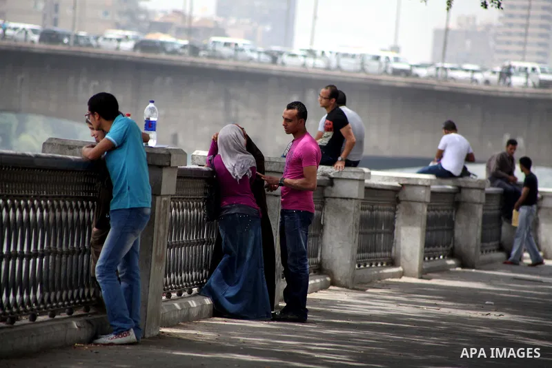 Egyptians sit together in front of Nile river in Cairo May 22, 2012. Egypt holds its first truly competitive leadership election in its history from Wednesday to pick the man to replace Hosni Mubarak, ousted last year in...