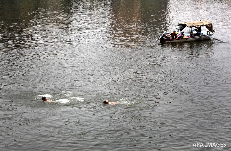 Egyptians enjoy swimming in the Nile River in Cairo, Egypt, May 22, 2012, one day before the country's landmark presidential elections. Photo by Ashraf Amra