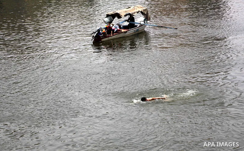 Egyptians enjoy swimming in the Nile River in Cairo, Egypt, May 22, 2012, one day before the country's landmark presidential elections. Photo by Ashraf Amra