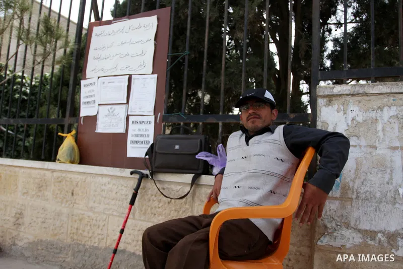 Palestinian Mahmoud Abu Joaed, holds firmly to the physically disabled 24 days in front of the Council of Ministers Palestinian in the West Bank city of Ramallah May 22, 2012. Tariq calls for the provision of jobs to sup...
