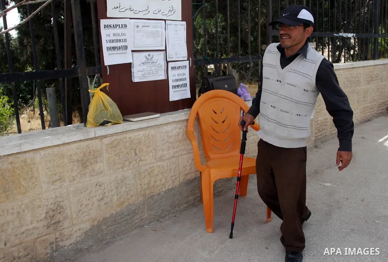 Palestinian Mahmoud Abu Joaed, holds firmly to the physically disabled 24 days in front of the Council of Ministers Palestinian in the West Bank city of Ramallah May 22, 2012. Tariq calls for the provision of jobs to sup...