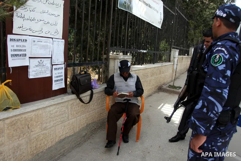 Palestinian Mahmoud Abu Joaed, holds firmly to the physically disabled 24 days in front of the Council of Ministers Palestinian in the West Bank city of Ramallah May 22, 2012. Tariq calls for the provision of jobs to sup...