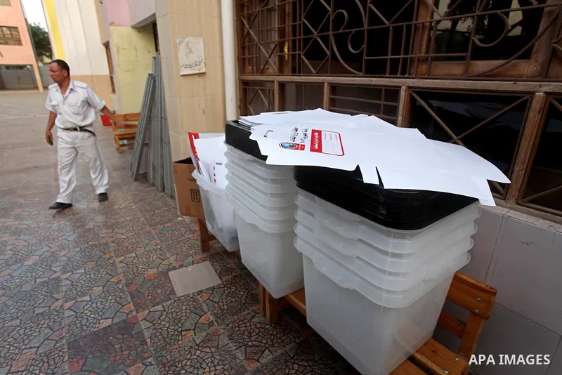 Egyptian policemen stacks notice boards and empty ballot boxes at a polling station in the Coptic neighbourhood of Manshiyet Nasser in Cairo on May 22, 2012. A buzz of excitement swept through the Egyptian capital on the...