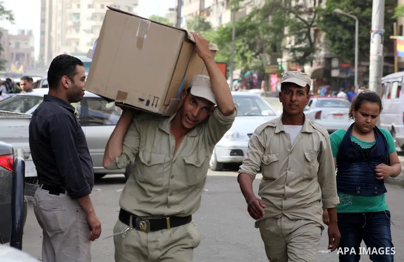 Egyptian soldiers carry cardboard boxes containing voting ballots in the capital Cairo on May 22, 2012, a day before the first presidential election since an uprising overthrew Hosni Mubarak. Around 50 million eligible v...