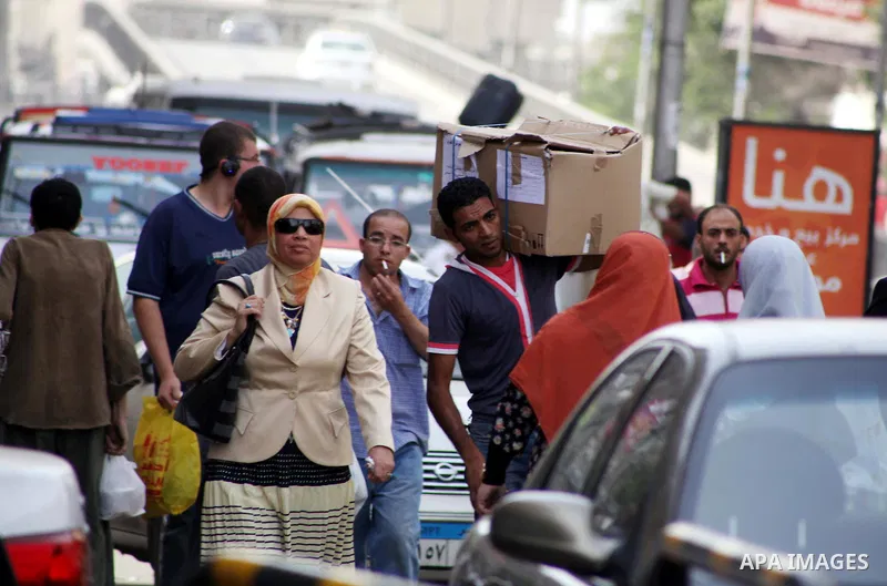 An Egyptian man carries a cardboard box containing voting ballots on his back in the capital Cairo on May 22, 2012, a day before the first presidential election since an uprising overthrew Hosni Mubarak. Around 50 millio...