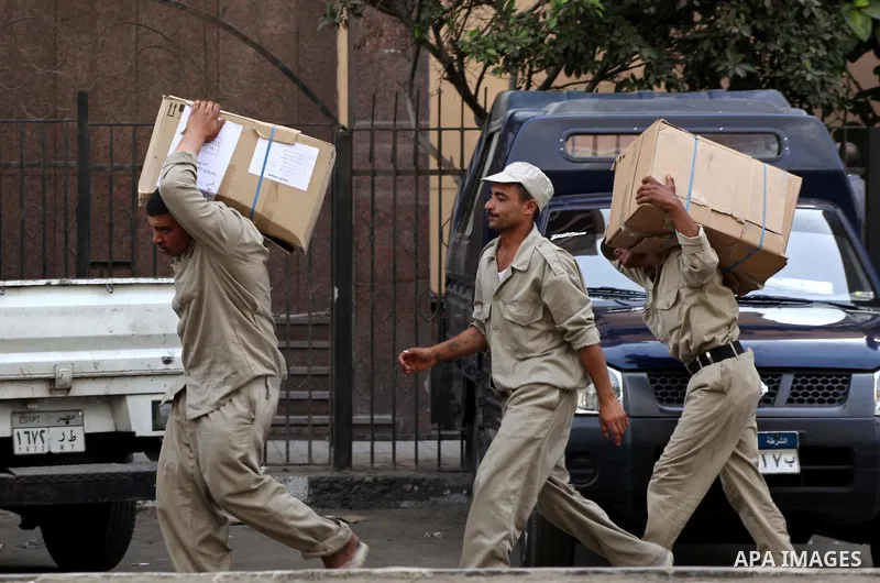 Egyptian soldiers carry cardboard boxes containing voting ballots in the capital Cairo on May 22, 2012, a day before the first presidential election since an uprising overthrew Hosni Mubarak. Around 50 million eligible v...
