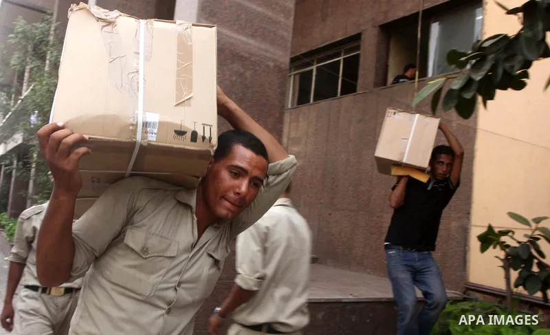 An Egyptian man carries a cardboard box containing voting ballots on his back in the capital Cairo on May 22, 2012, a day before the first presidential election since an uprising overthrew Hosni Mubarak. Around 50 millio...