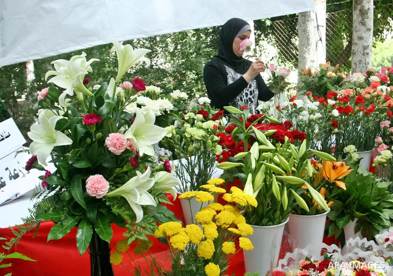A Palestinian woman participates in the opening of Palestinian agricultural festival at strawberry and roses , in the West Bank city of Nablus on May 23, 2012. Photo by Nedal Eshtayah