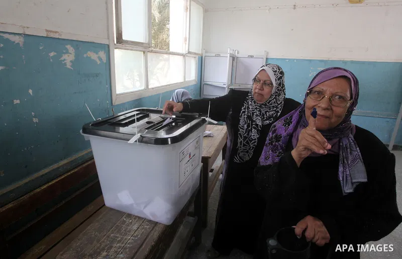 Egyptian woman shows her ink-marked finger after casting her ballot during the first round of Egypt's presidential elections, at a polling station in Cairo, Egypt, 23 May 2012. Egyptian voters, on 23 May, queued at polli...