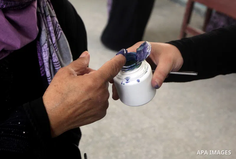 Egyptian voter dips his finger in the ink to cast his ballot during the first round of Egypt's presidential elections, at a polling station in Cairo, Egypt, 23 May 2012. Egyptian voters, on 23 May, queued at polling stat...