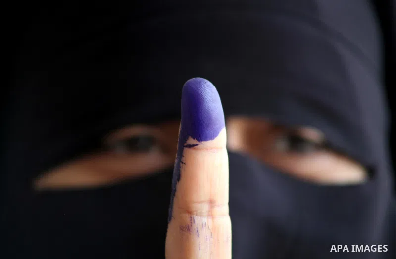 Egyptian woman shows her ink-marked finger after casting her ballot during the first round of Egypt's presidential elections, at a polling station in Cairo, Egypt, 23 May 2012. Egyptian voters, on 23 May, queued at polli...