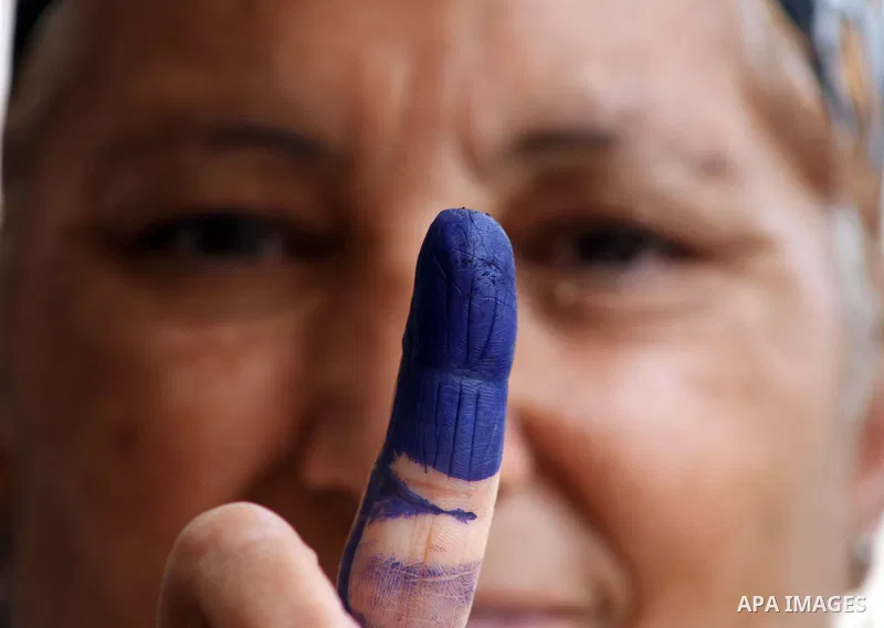 Egyptian woman shows her ink-marked finger after casting her ballot during the first round of Egypt's presidential elections, at a polling station in Cairo, Egypt, 23 May 2012. Egyptian voters, on 23 May, queued at polli...