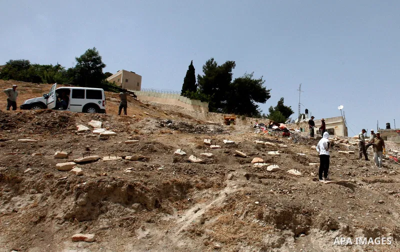 Palestinians walk on a land ready to be confiscated by israel authority as a cemetery for jewish in silwan Jerusalem's old city on May 23, 2012. Photo by Mahfouz Abu Turk