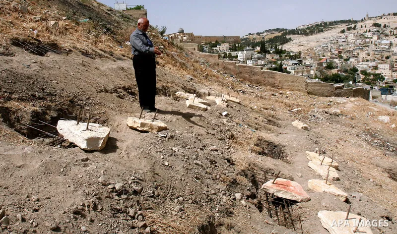 A Palestinian man walks on a land ready to be confiscated by israel authority as a cemetery for jewish in silwan Jerusalem's old city on May 23, 2012. Photo by Mahfouz Abu Turk